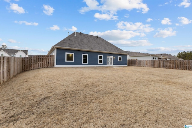 rear view of property with a lawn