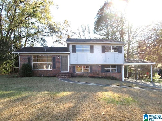 tri-level home featuring a carport and a front lawn