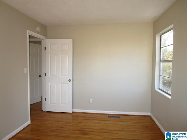 empty room featuring hardwood / wood-style flooring