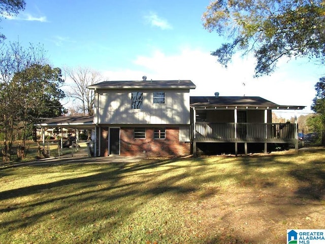 back of property with a yard and a deck