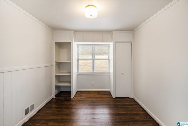 unfurnished bedroom featuring ornamental molding, visible vents, and dark wood finished floors