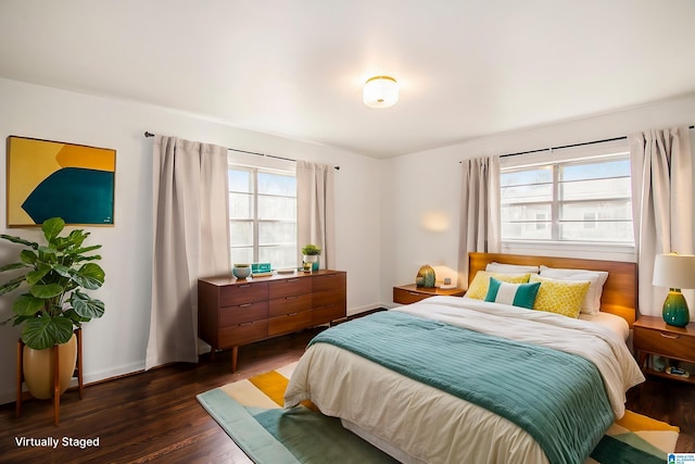 bedroom with baseboards and dark wood-style flooring