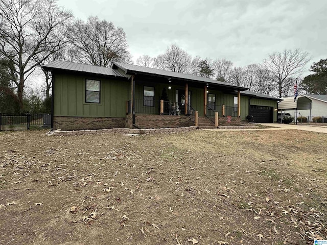 single story home with a garage and covered porch