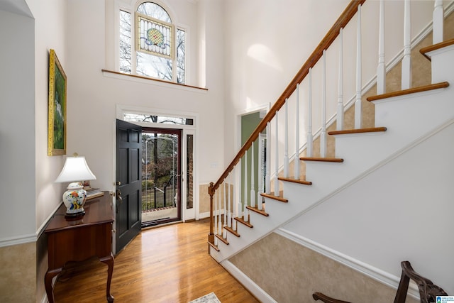 entrance foyer with plenty of natural light, a high ceiling, and light wood-type flooring