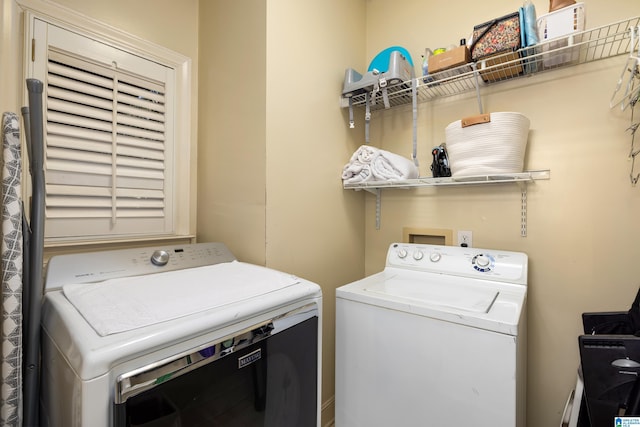 washroom with independent washer and dryer