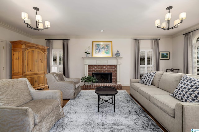 living room with crown molding, a healthy amount of sunlight, and an inviting chandelier