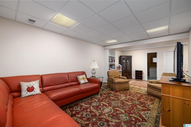 living room featuring a drop ceiling