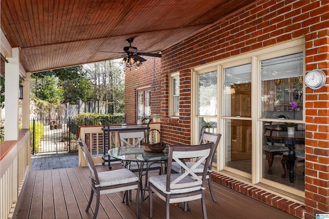 wooden terrace with a porch and ceiling fan