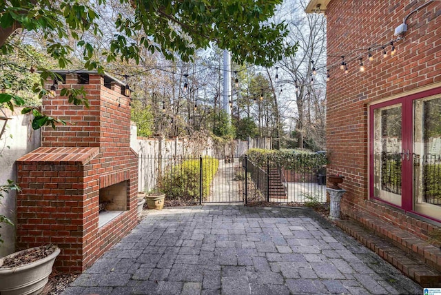 view of patio / terrace with an outdoor brick fireplace