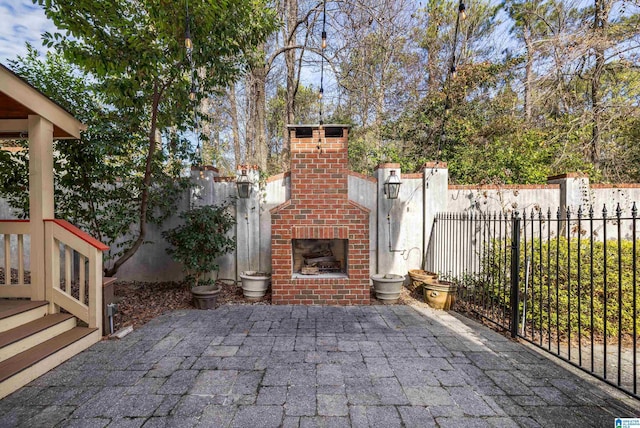 view of patio / terrace featuring an outdoor brick fireplace