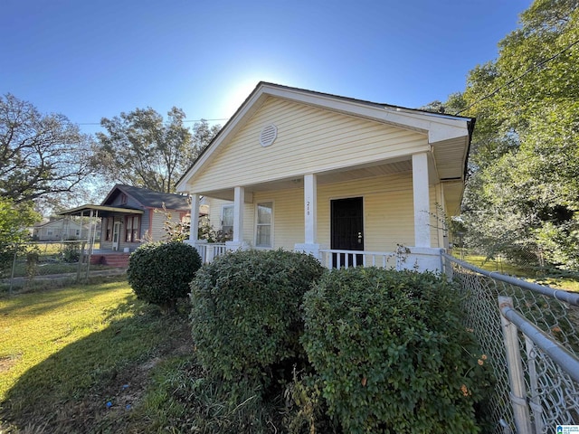 exterior space featuring a porch and a front yard