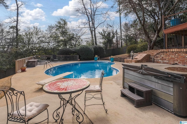 view of swimming pool featuring a patio area and a diving board