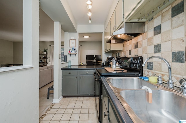 kitchen featuring sink, gray cabinetry, decorative backsplash, light tile patterned floors, and black / electric stove