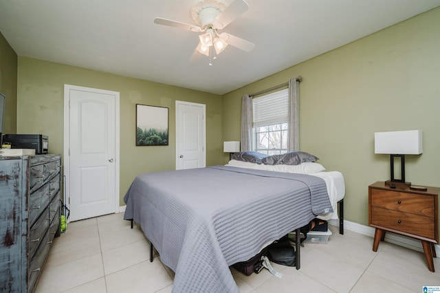 bedroom with ceiling fan and light tile patterned floors