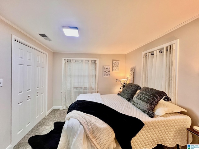 carpeted bedroom featuring ornamental molding and a closet