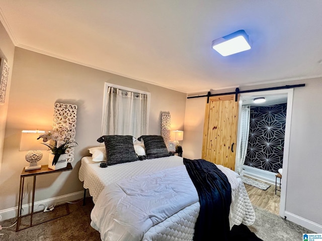 bedroom with ornamental molding and a barn door