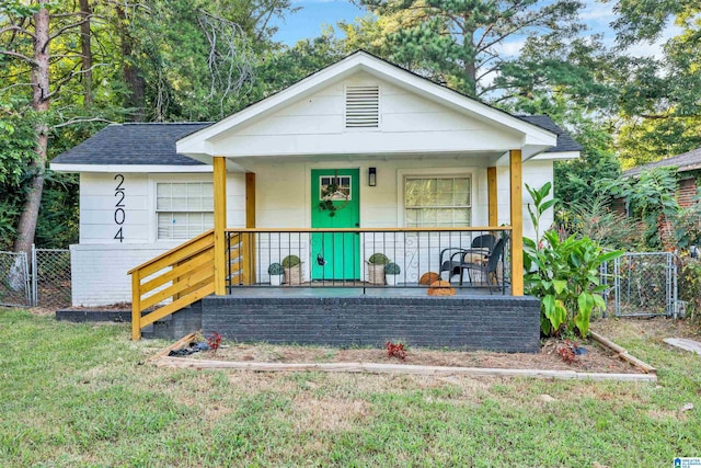 bungalow-style house featuring a front yard and covered porch