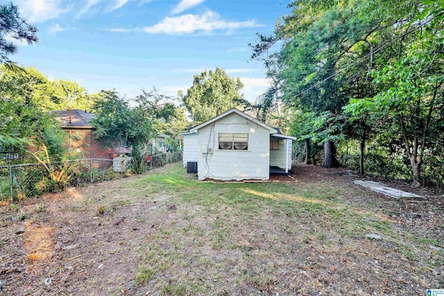 exterior space with a yard and central air condition unit