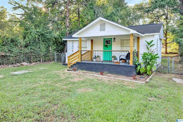 rear view of property with a porch and a yard