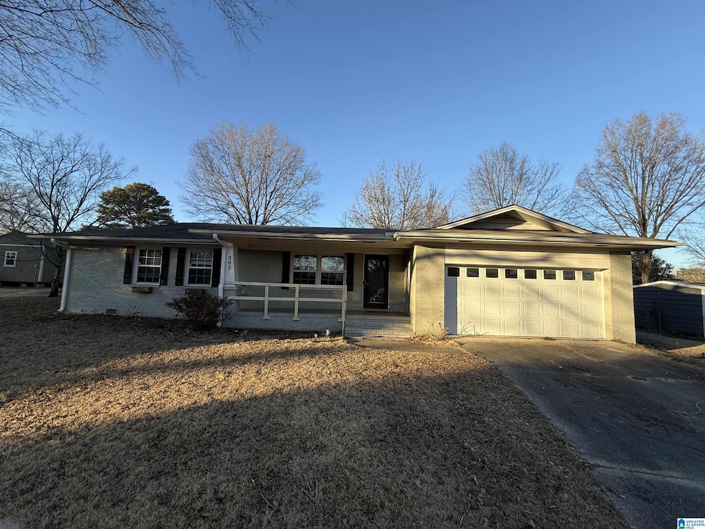 ranch-style home featuring a porch and a garage