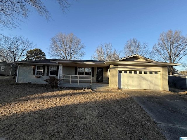 ranch-style home with a porch, a garage, brick siding, concrete driveway, and crawl space