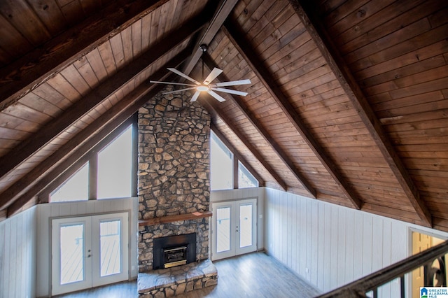 unfurnished living room featuring wood ceiling, hardwood / wood-style floors, high vaulted ceiling, french doors, and beamed ceiling