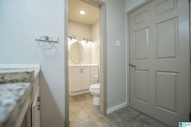 bathroom featuring vanity, toilet, and tile patterned flooring