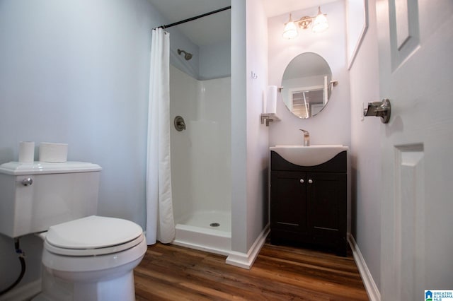 bathroom featuring walk in shower, vanity, toilet, and hardwood / wood-style flooring