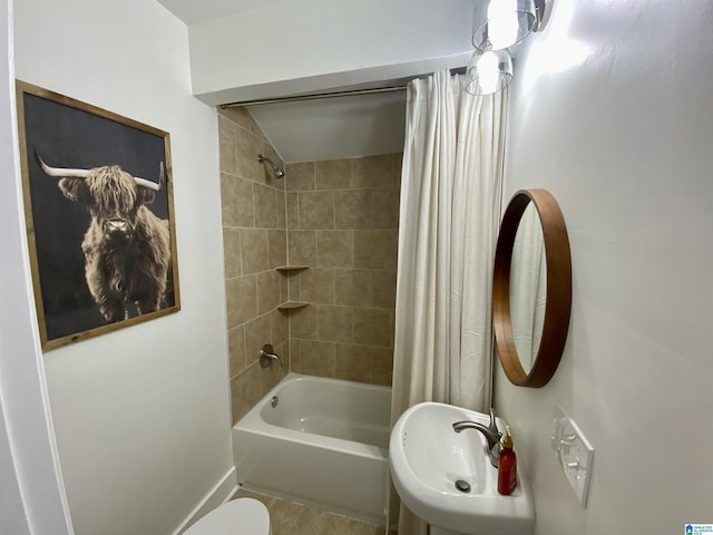 full bathroom with sink, toilet, and shower / bath combo with shower curtain