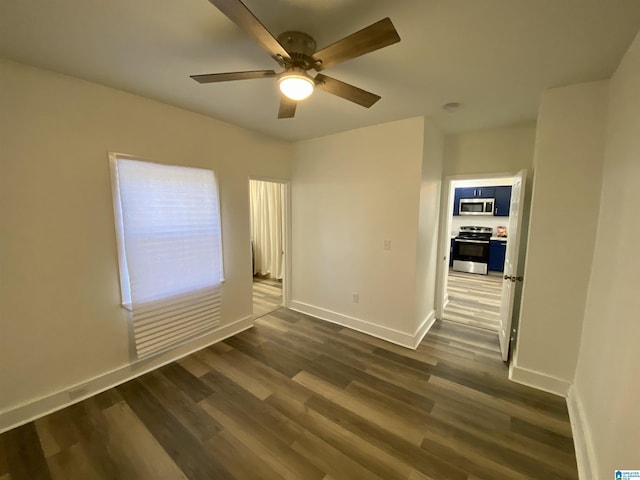 unfurnished room with dark hardwood / wood-style flooring and ceiling fan