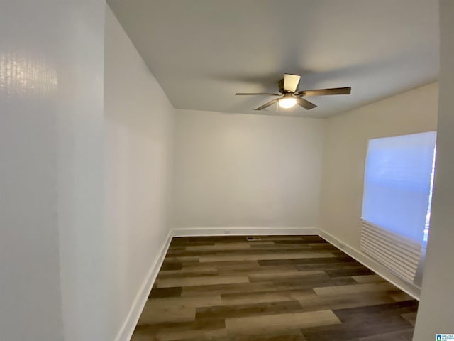 unfurnished room with ceiling fan and dark hardwood / wood-style flooring