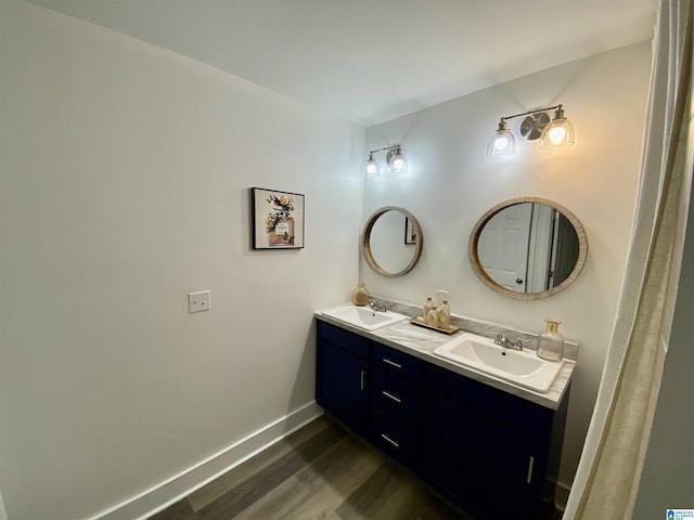 bathroom with vanity and wood-type flooring