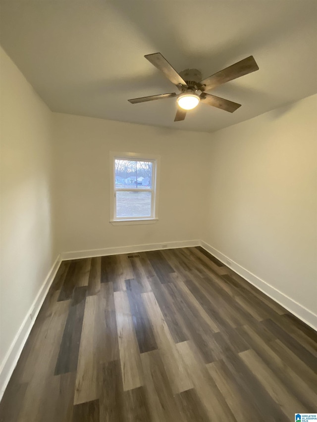 unfurnished room featuring ceiling fan and dark wood-type flooring