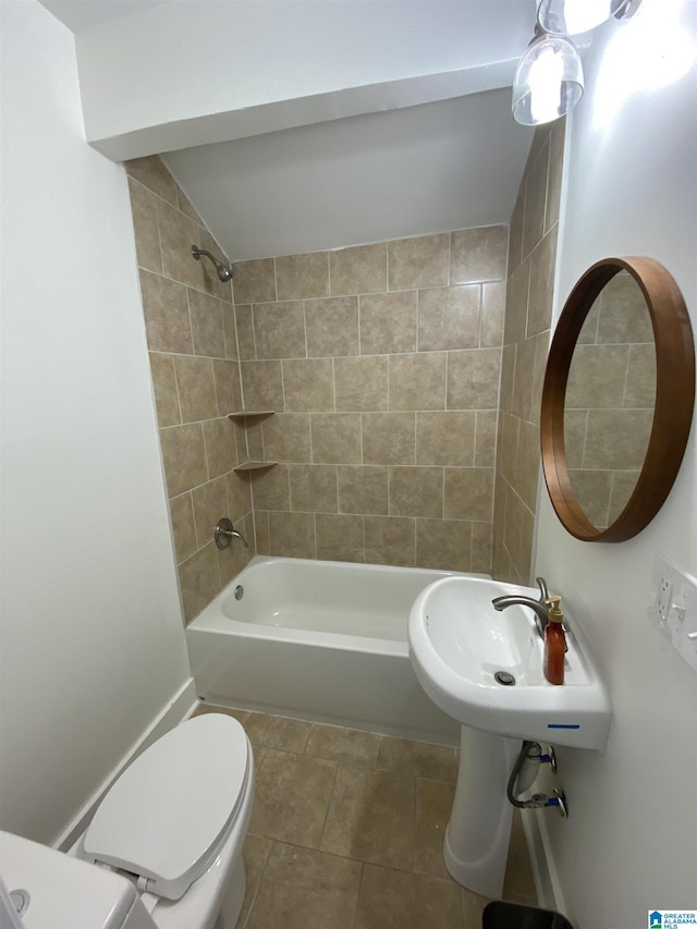 full bathroom with tiled shower / bath combo, sink, tile patterned flooring, and toilet