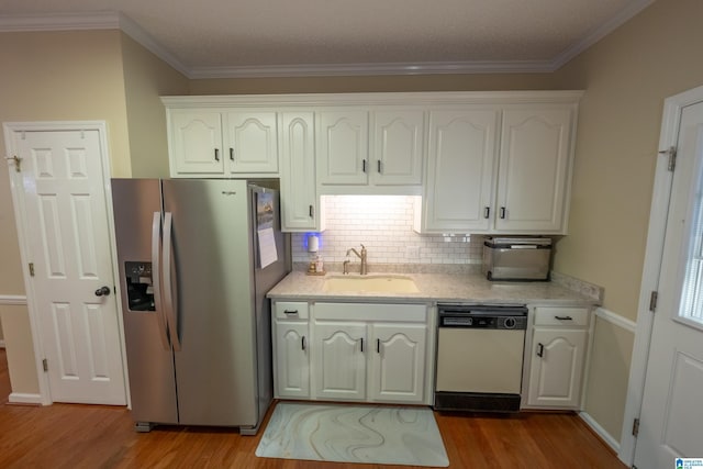 kitchen with white dishwasher, sink, white cabinets, and stainless steel refrigerator with ice dispenser