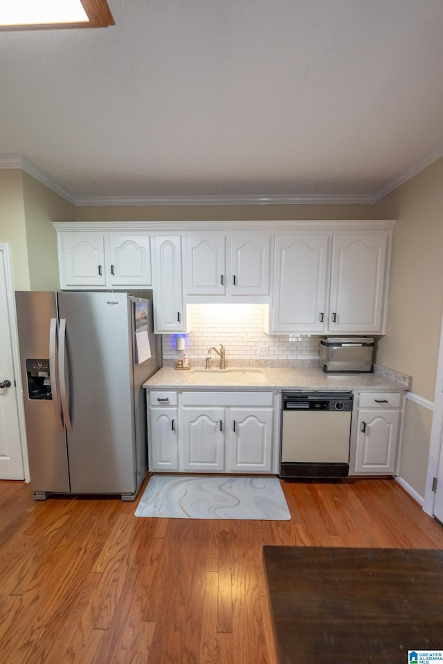 kitchen featuring white cabinetry, sink, white dishwasher, and stainless steel fridge with ice dispenser