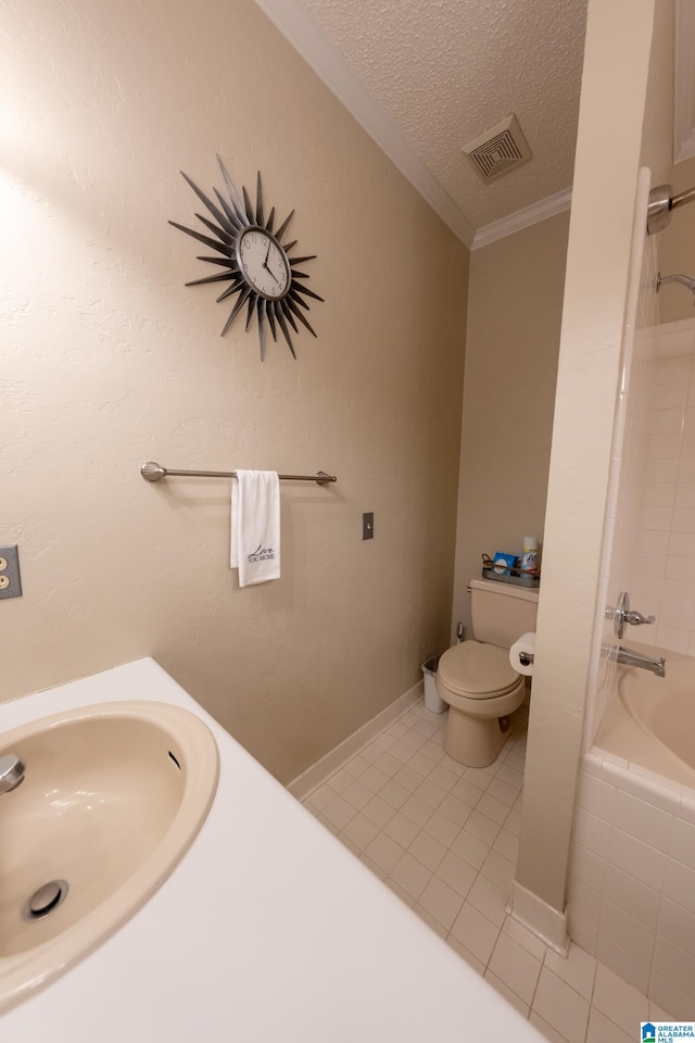 full bathroom with toilet, sink, a textured ceiling, ornamental molding, and tile patterned flooring