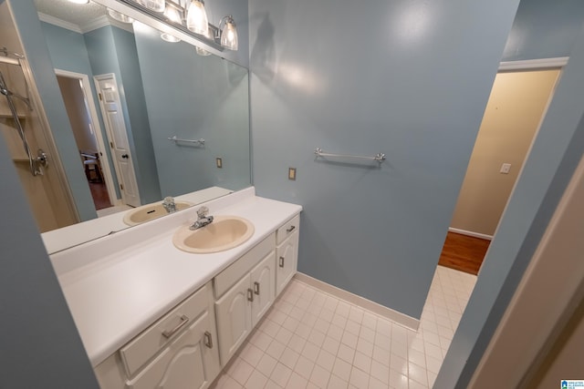 bathroom with crown molding, tile patterned floors, and vanity