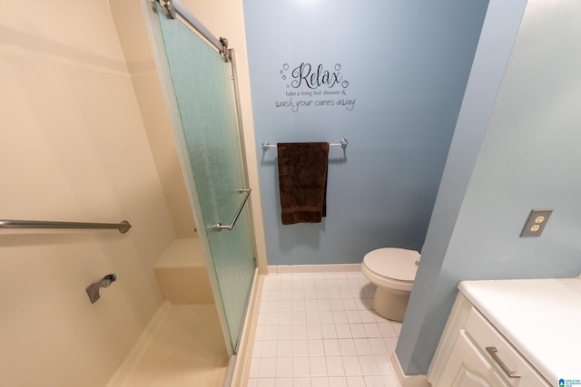 bathroom featuring vanity, toilet, tile patterned flooring, and a shower with door