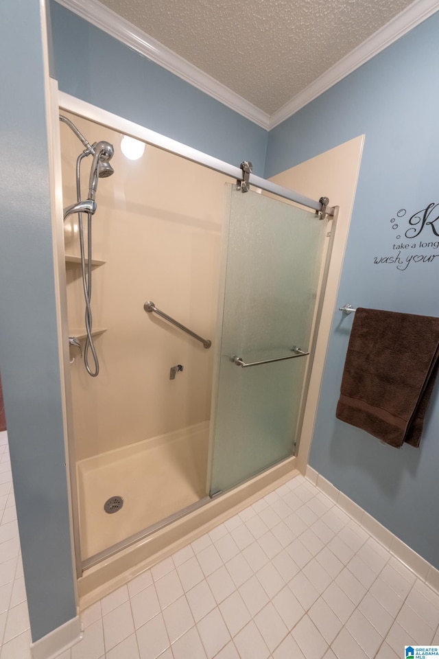 bathroom with a shower with door, ornamental molding, tile patterned flooring, and a textured ceiling