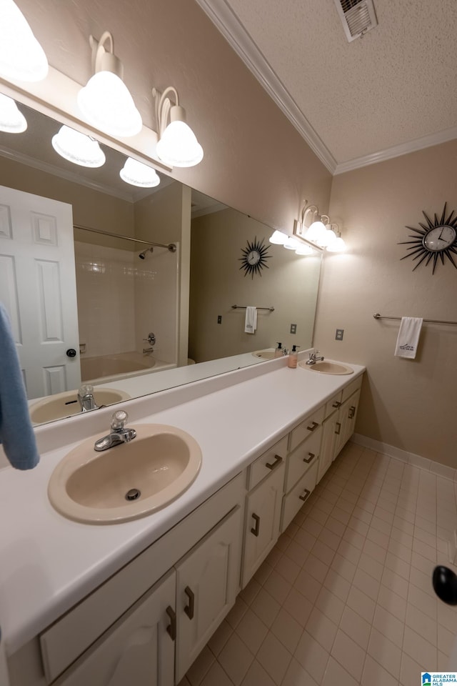 bathroom with shower / washtub combination, vanity, ornamental molding, a textured ceiling, and tile patterned floors