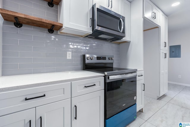 kitchen with white cabinetry, light tile patterned floors, backsplash, and appliances with stainless steel finishes