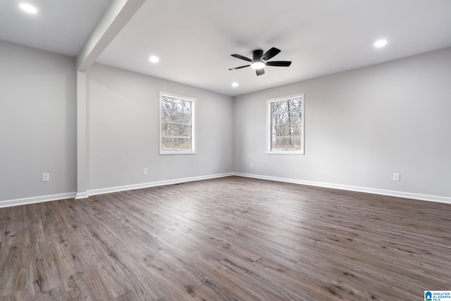 spare room with dark hardwood / wood-style flooring and ceiling fan