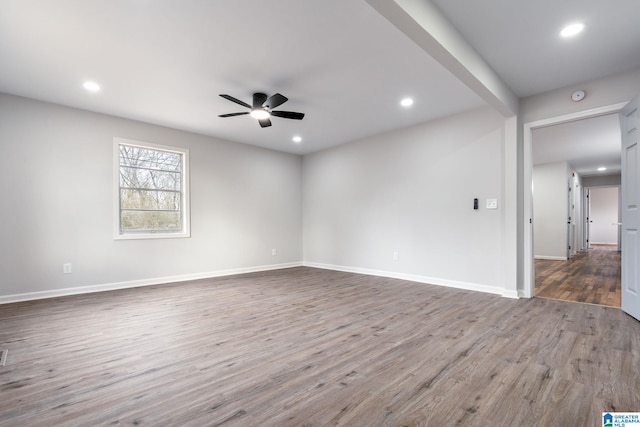 empty room featuring hardwood / wood-style floors and ceiling fan