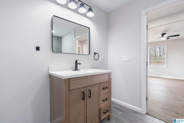 bathroom with vanity, hardwood / wood-style flooring, and ceiling fan