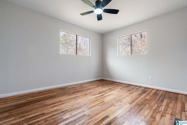 unfurnished room with ceiling fan and hardwood / wood-style floors