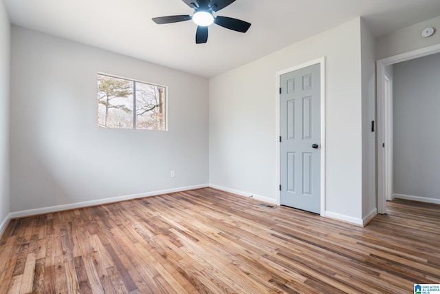 unfurnished bedroom with ceiling fan and light hardwood / wood-style floors