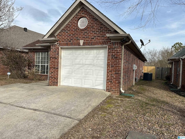 view of home's exterior with a garage and central air condition unit