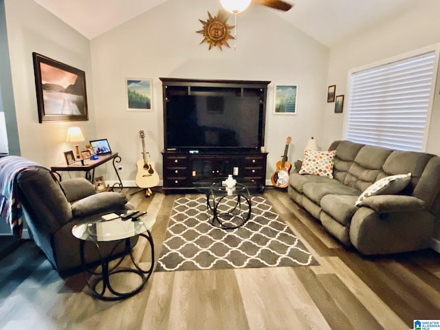 living room featuring hardwood / wood-style flooring, vaulted ceiling, and ceiling fan