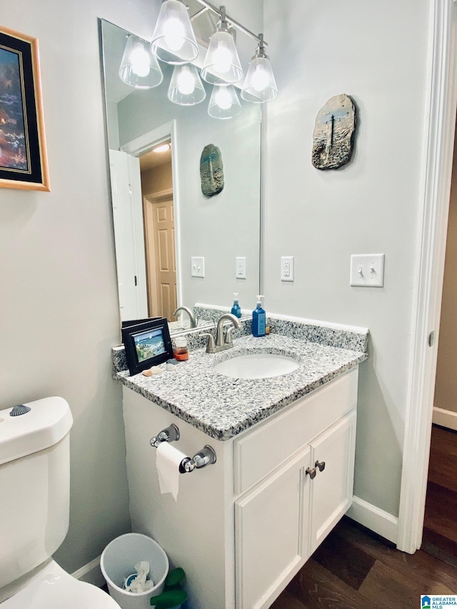 bathroom featuring hardwood / wood-style flooring, vanity, and toilet